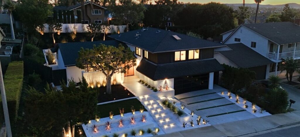 exterior of modern style home for sale by Mission Viejo real estate agent at night time