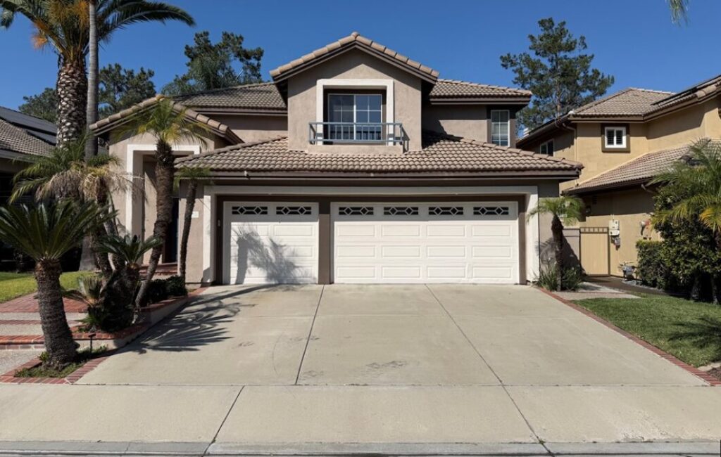 front of stucco home with 3 car garage listed for sale by Mission Viejo real estate agents